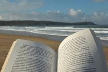 Open book in foreground with beach in background