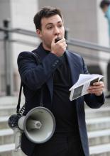 Alex Lenferna speaking into a megaphone