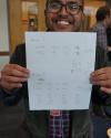 Paul Tubig shows scores from the rounds of the ethics bowl.
