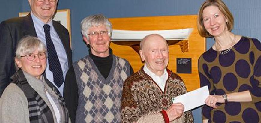 Lonnie Robinson presents a check to Philosophy Chair Andrea Woody. Also present are (from left) History Professor Emeritus Thomas Hankins and Lonnie Robinson's son and daughter, Larry Robinson and Jane Ritchey .