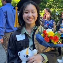 Graduate with bear and flowers